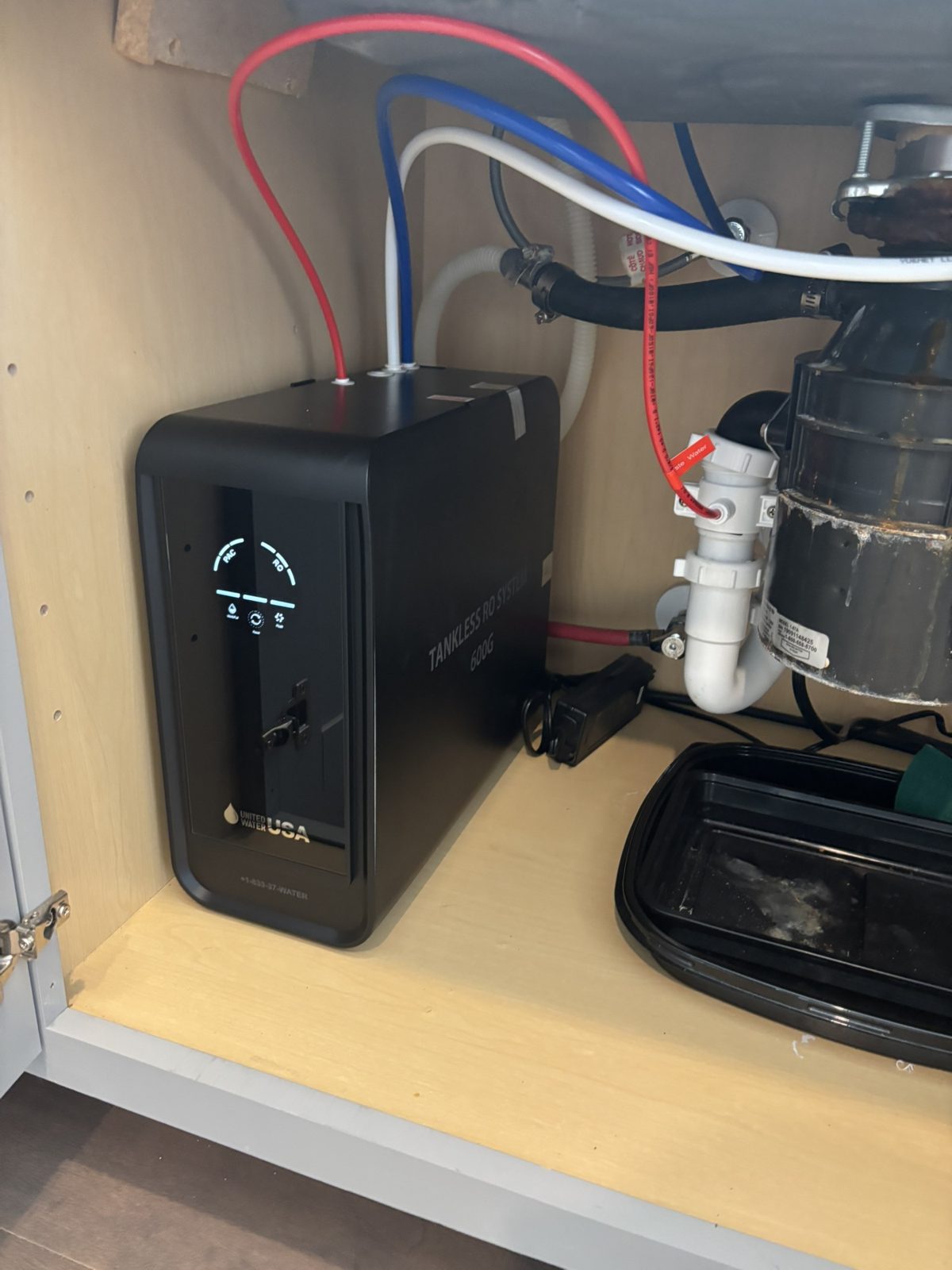 Under-sink reverse osmosis system installed by H2Ome in a kitchen cabinet