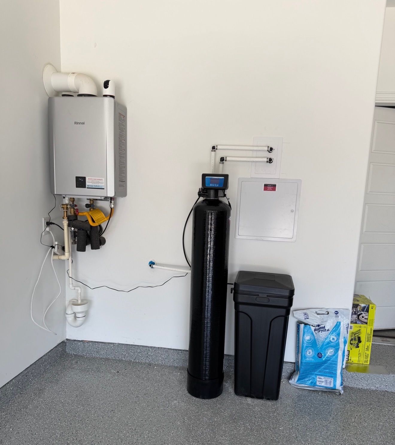 Whole-home water softener installed by H2Ome in a North Texas garage